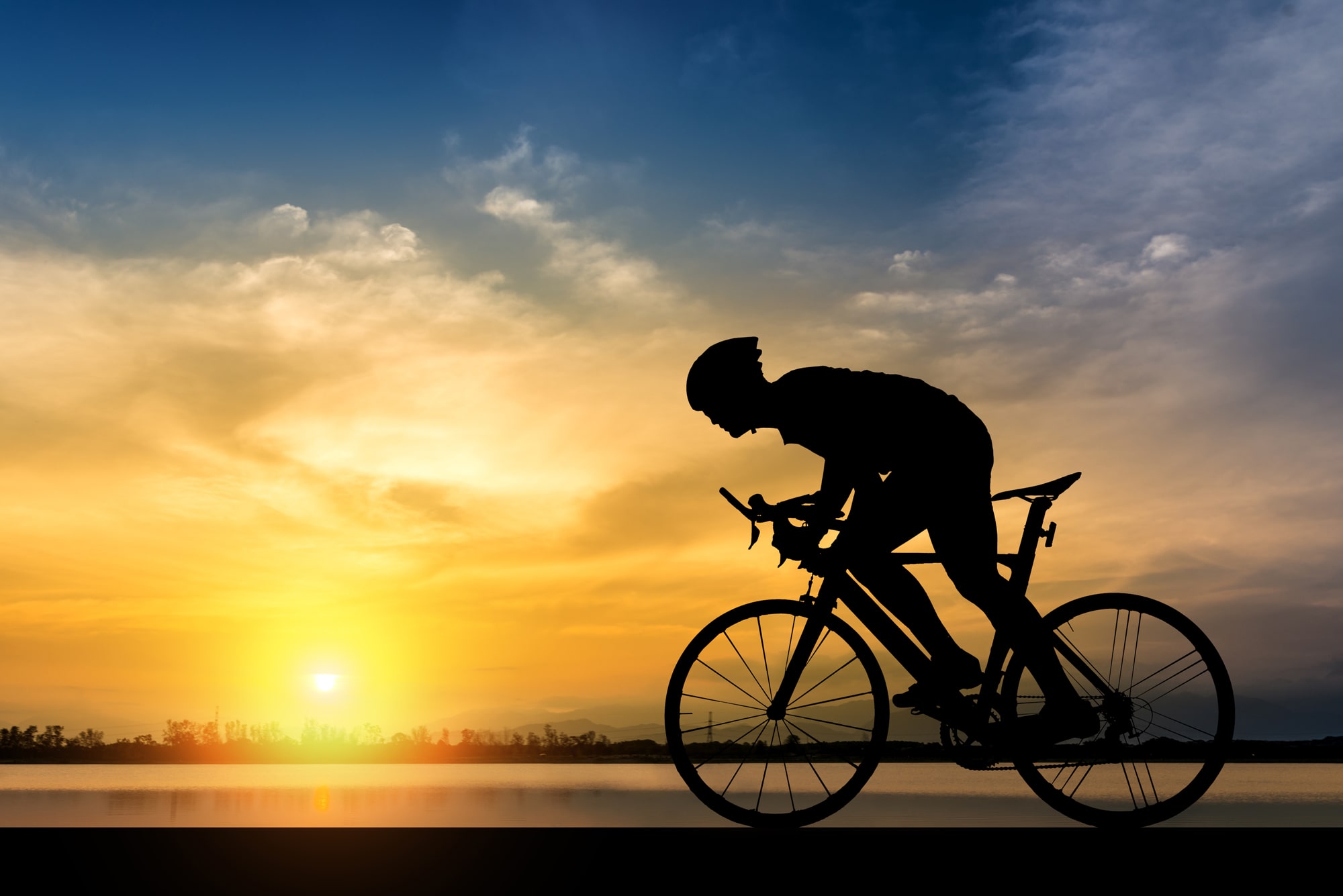 bike-rider-sunrise bicycle rider in front of a sunrise